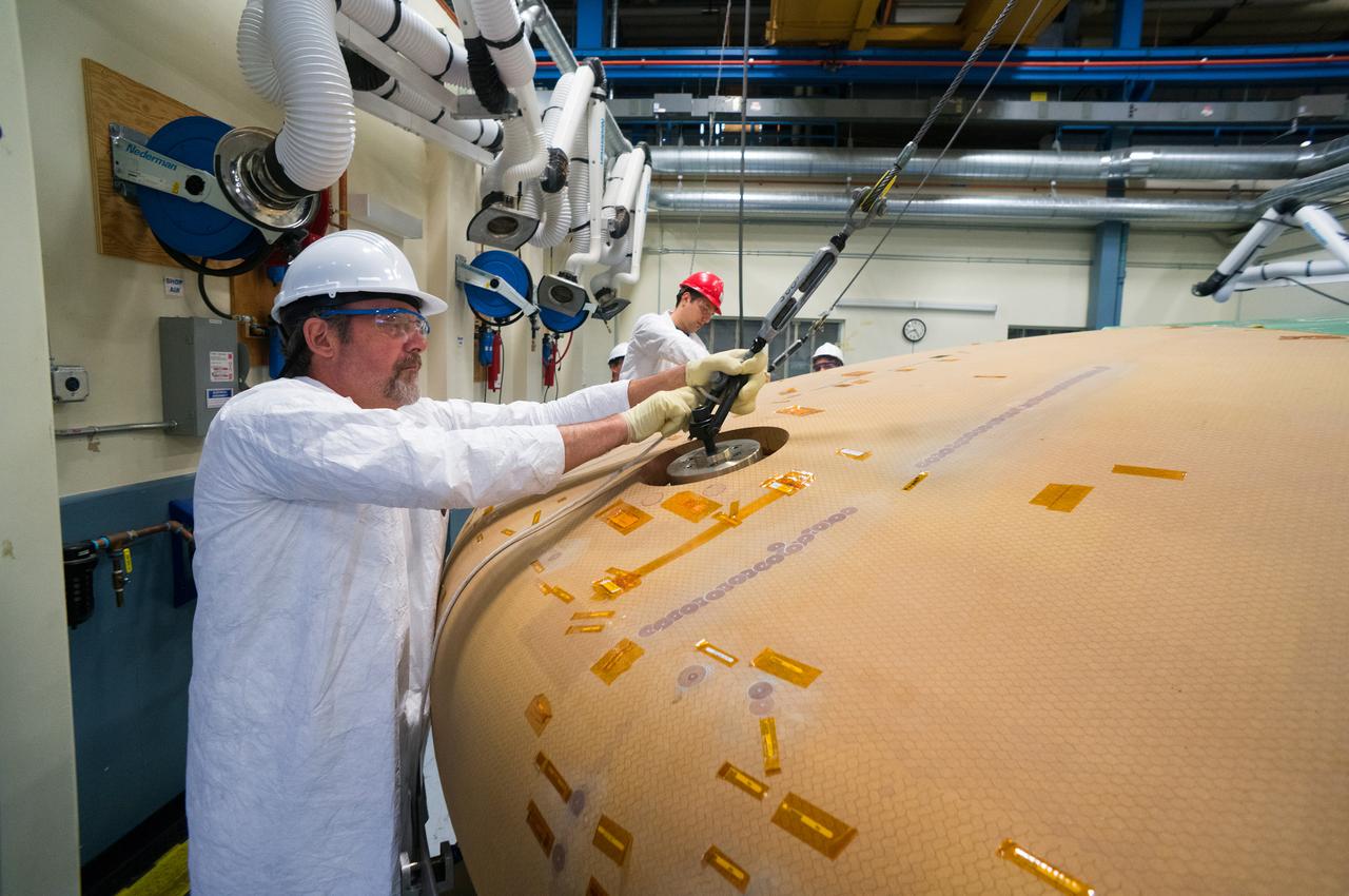 Technicians at Textron in Wimington, MA, move the Exploration Flight Test-1 (EFT-1) Orion heat shield into position for X-ray testing on Nov. 23, 2013. Part of Batch image transfer from Flickr.