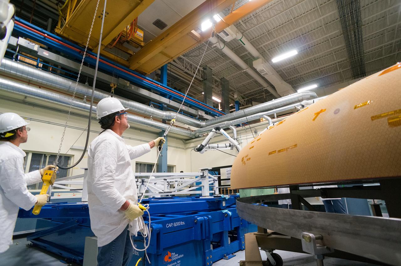 Technicians at Textron in Wimington, MA, move the Exploration Flight Test-1 (EFT-1) Orion heat shield into position for X-ray testing on Nov. 23, 2013. Part of Batch image transfer from Flickr.