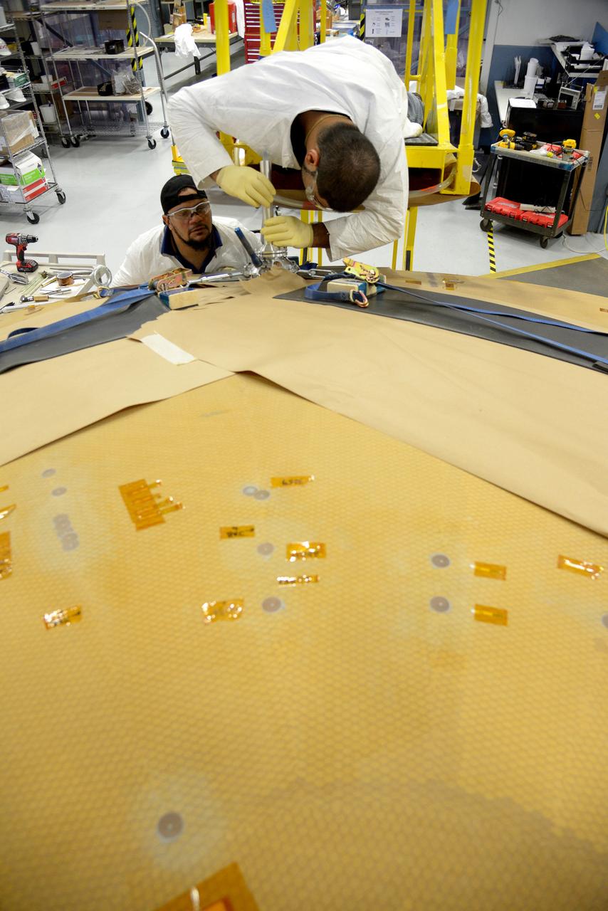 Technicians at Textron in Wimington, MA, drill repair plugs on the Exploration Flight Test-1 (EFT-1) Orion heat shield on Nov. 24, 2013. Part of Batch image transfer from Flickr.
