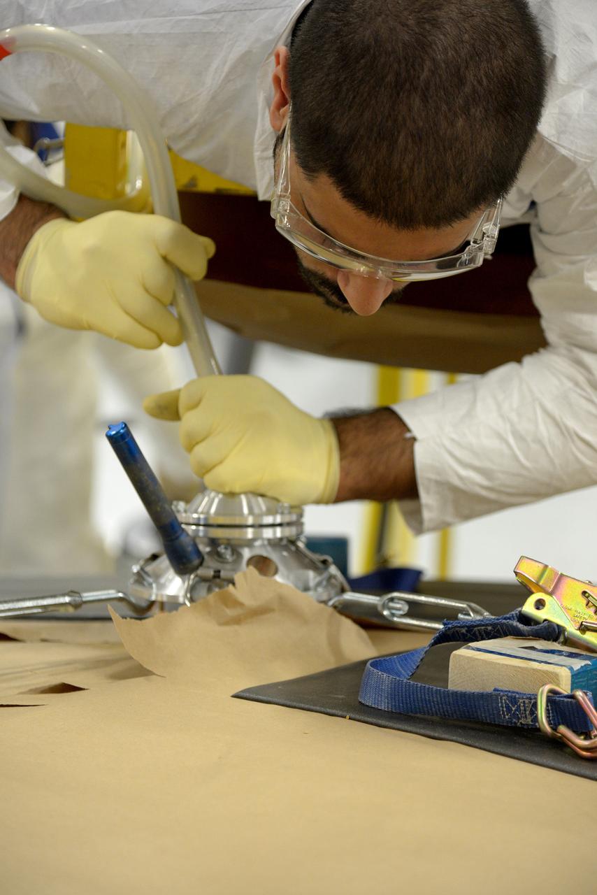 Technicians at Textron in Wimington, MA, drill repair plugs on the Exploration Flight Test-1 (EFT-1) Orion heat shield on Nov. 24, 2013. Part of Batch image transfer from Flickr.
