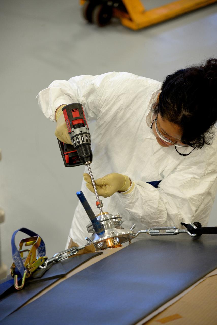 Technicians at Textron in Wimington, MA, drill repair plugs on the Exploration Flight Test-1 (EFT-1) Orion heat shield on Nov. 24, 2013. Part of Batch image transfer from Flickr.