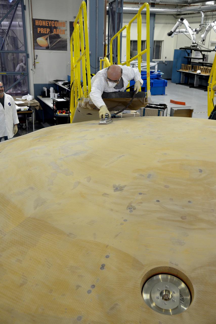 Technicians at Textron in Wimington, MA, perform final sanding on the Exploration Flight Test-1 (EFT-1) Orion heat shield on Nov. 25, 2013. Part of Batch image transfer from Flickr.
