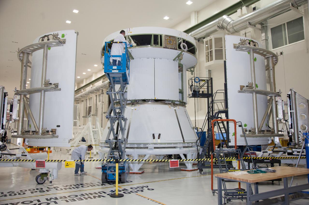Technicians work on the Exploration Flight Test-1 (EFT-1) Orion service module in the Operations and Checkout Building (O&C) at Kennedy Space Center on Dec. 2, 2013. Part of Batch image transfer from Flickr.