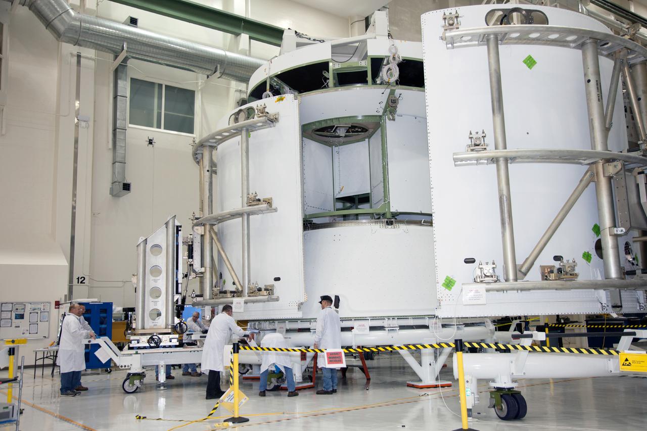 Technicians work on the Exploration Flight Test-1 (EFT-1) Orion service module in the Operations and Checkout Building (O&amp;C) at Kennedy Space Center on Dec. 24, 2013. Part of Batch image transfer from Flickr.