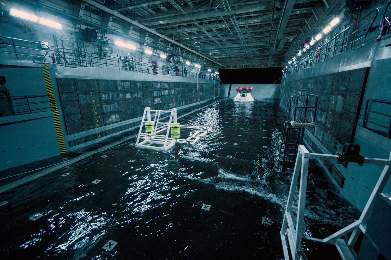 A test version of the Orion spacecraft is tethered inside the well deck of the USS San Diego on Feb. 18, 2014, prior to tests that will allow NASA and the Navy to practice the procedures they'll use to recover Orion from the Pacific Ocean on Exploration Flight Test-1 (EFT-1). To safely bring Orion home after splashdown, it will be towed into the flooded well deck and secured in a specially-designed cradle before the water is drained. Part of Batch image transfer from Flickr.