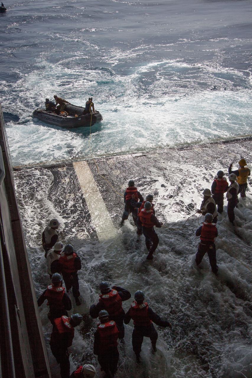 NASA and the U.S. Navy conduct a test on Feb. 20, 2014 in the Pacific Ocean, about 100 miles off the coast of San Diego, California, to prepare for the recovery of the Orion crew module, forward bay cover and parachutes on its return from a deep space mission. The underway recovery test will allow the teams to demonstrate and evaluate the recovery processes, procedures, hardware and personnel in open waters. Part of Batch image transfer from Flickr.