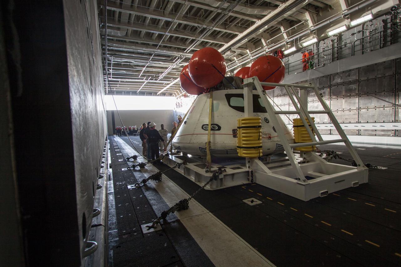 The Orion boilerplate test vehicle is secured in the well deck of the USS San Diego at the U.S. Naval Base San Diego in California on Feb. 20, 2014. Orion was transported about 100 miles offshore for an underway recovery test. NASA and the U.S. Navy conducted tests to prepare for recovery of the Orion crew module, forward bay cover and parachutes on its return from a deep space mission. The underway recovery tests allow the teams to demonstrate and evaluate the recovery processes, procedures, hardware and personnel in open waters. Part of Batch image transfer from Flickr.