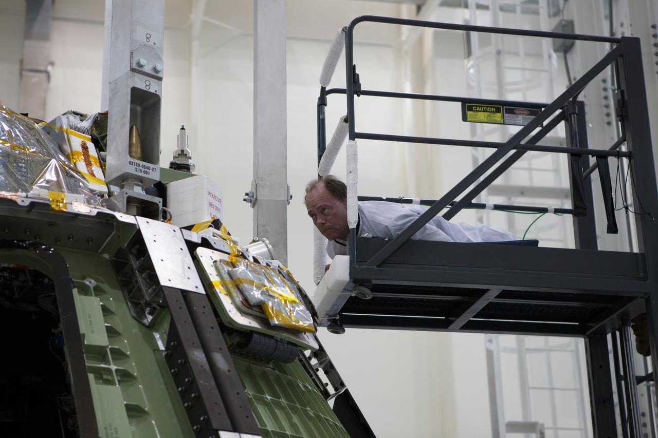 The Orion Exploration Flight Test-1 (EFT-1) crew module is prepared for mating with the heat shield in the Operations and Checkout (O&amp;C) Building at Kennedy Space Center on May 9, 2014. Part of Batch image transfer from Flickr.