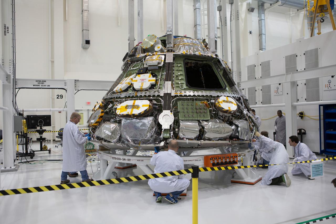 The Orion Exploration Flight Test-1 (EFT-1) crew module is prepared for mating with the heat shield in the Operations and Checkout (O&amp;C) Building at Kennedy Space Center on May 9, 2014. Part of Batch image transfer from Flickr.