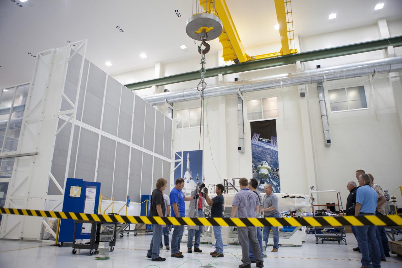 The Orion Exploration Flight Test-1 (EFT-1) crew module is prepared for mating with the heat shield in the Operations and Checkout (O&amp;C) Building at Kennedy Space Center on May 9, 2014. Part of Batch image transfer from Flickr.