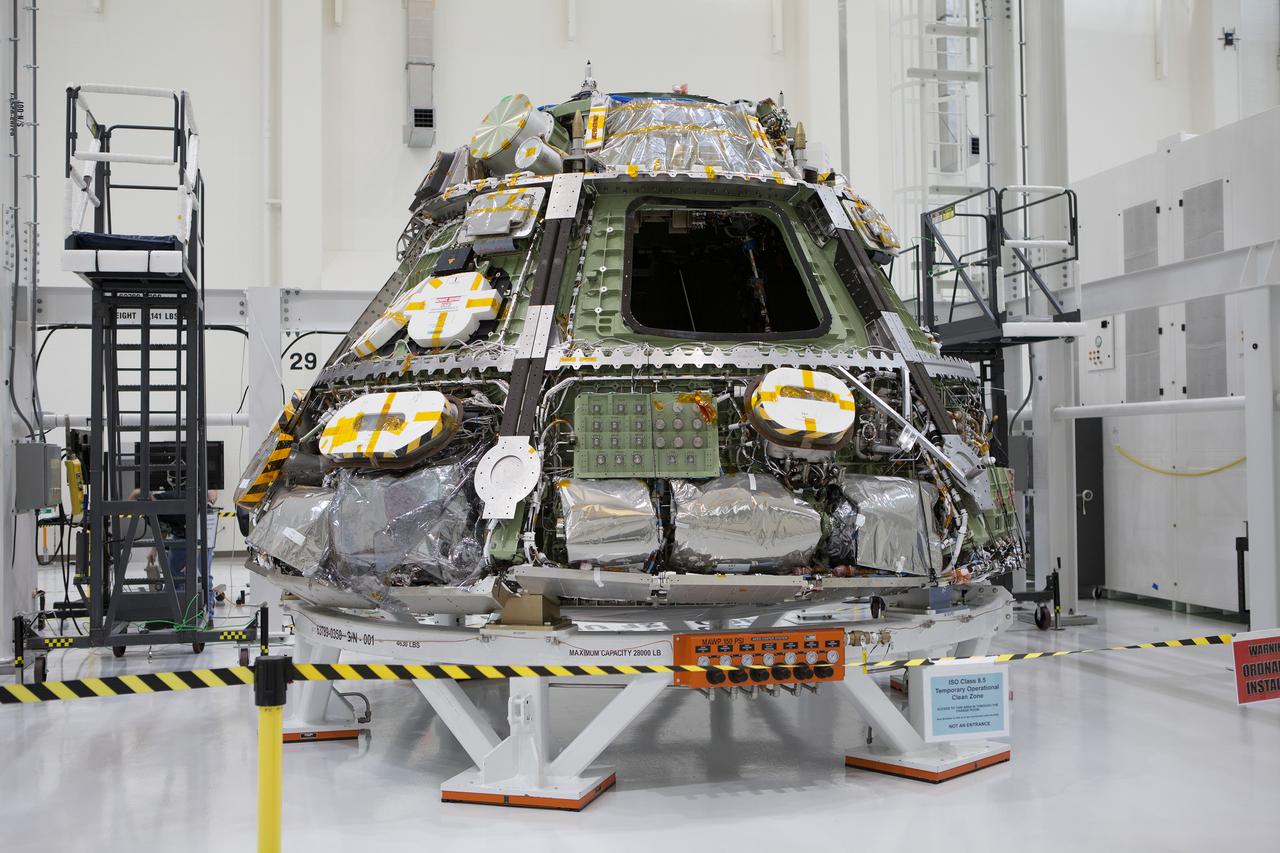 The Orion Exploration Flight Test-1 (EFT-1) crew module is prepared for mating with the heat shield in the Operations and Checkout (O&amp;C) Building at Kennedy Space Center on May 9, 2014. Part of Batch image transfer from Flickr.