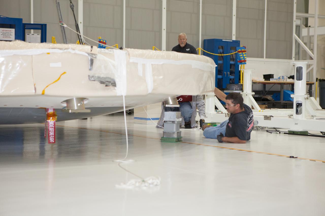 The Orion Exploration Flight Test-1 (EFT-1) crew module is prepared for mating with the heat shield in the Operations and Checkout (O&amp;C) Building at Kennedy Space Center on May 9, 2014. Part of Batch image transfer from Flickr.