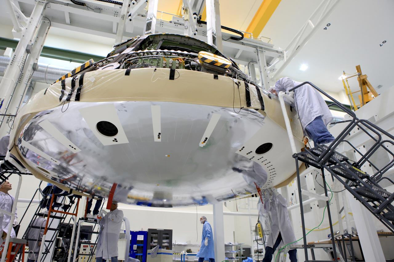 The world’s largest heat shield, measuring 16.5 feet in diameter, is successfully attached to the Orion Exploration Flight Test-1 (EFT-1) spacecraft on May 30, 2014. The heat shield is made from a single seamless piece of Avcoat ablator. The heat shield was tested on Orion’s first flight as it protected the spacecraft from temperatures reaching 4,000 degrees Fahrenheit. Part of Batch image transfer from Flickr.