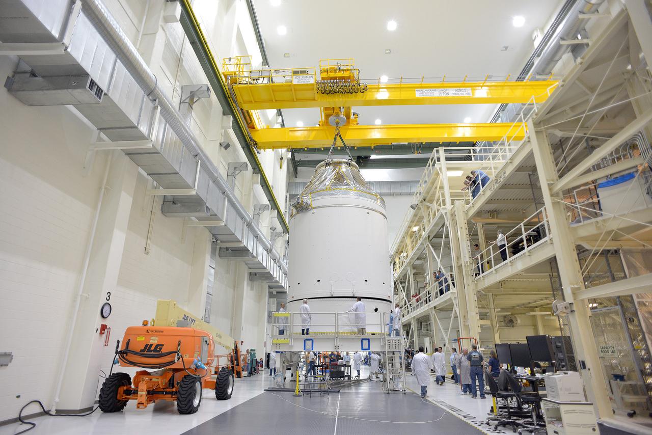 Technicians and engineers put finishing touches on the Orion Exploration Flight Test-1 (EFT-1) crew module and service module stack in the Operations and Checkout (O&amp;C) Building at Kennedy Space Center on Sept. 7, 2014. Part of Batch image transfer from Flickr.
