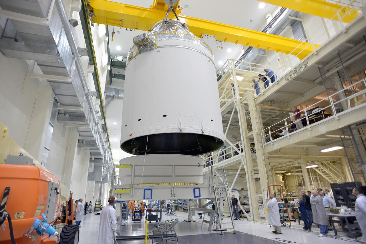 Technicians and engineers put finishing touches on the Orion Exploration Flight Test-1 (EFT-1) crew module and service module stack in the Operations and Checkout (O&amp;C) Building at Kennedy Space Center on Sept. 7, 2014. Part of Batch image transfer from Flickr.