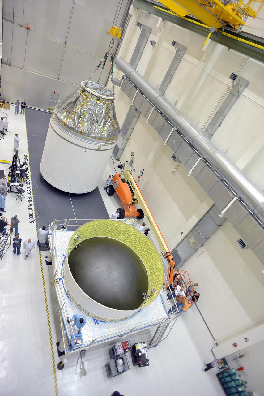 Technicians and engineers put finishing touches on the Orion Exploration Flight Test-1 (EFT-1) crew module and service module stack in the Operations and Checkout (O&amp;C) Building at Kennedy Space Center on Sept. 7, 2014. Part of Batch image transfer from Flickr.