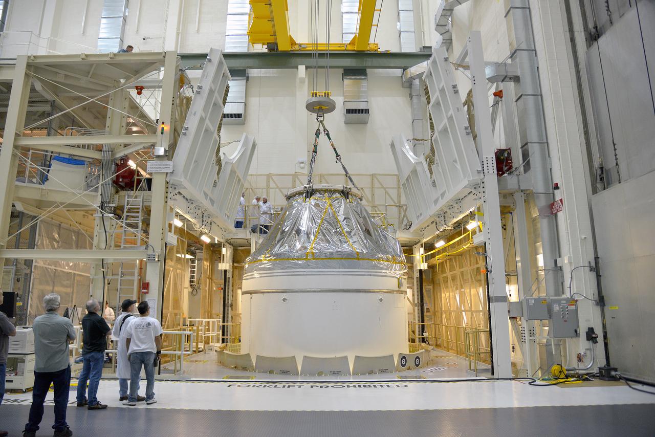Technicians and engineers put finishing touches on the Orion Exploration Flight Test-1 (EFT-1) crew module and service module stack in the Operations and Checkout (O&amp;C) Building at Kennedy Space Center on Sept. 7, 2014. Part of Batch image transfer from Flickr.