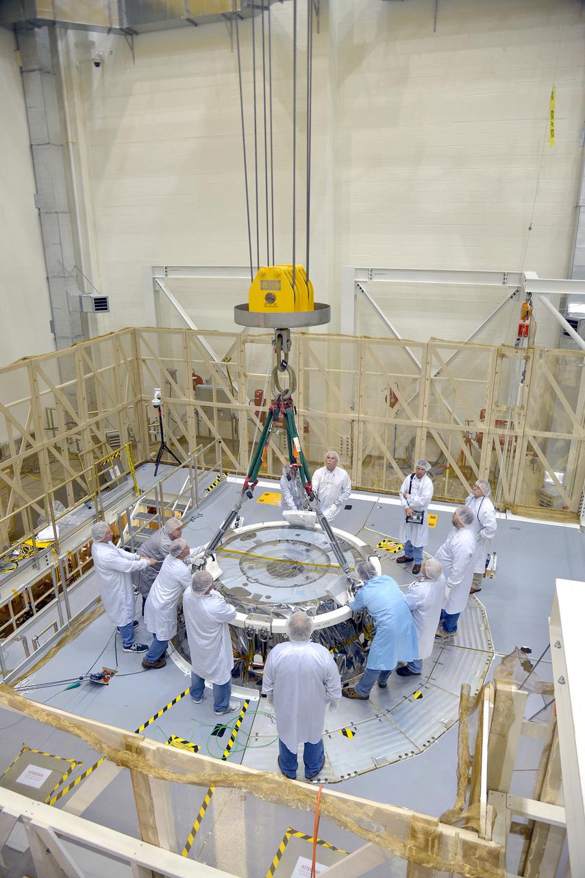 Technicians and engineers put finishing touches on the Orion Exploration Flight Test-1 (EFT-1) crew module and service module stack in the Operations and Checkout (O&amp;C) Building at Kennedy Space Center on Sept. 7, 2014. Part of Batch image transfer from Flickr.