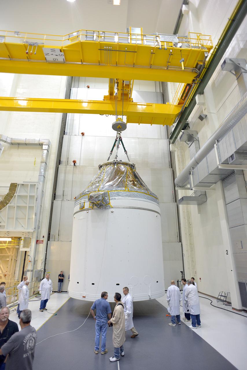 Technicians and engineers put finishing touches on the Orion Exploration Flight Test-1 (EFT-1) crew module and service module stack in the Operations and Checkout (O&amp;C) Building at Kennedy Space Center on Sept. 7, 2014. Part of Batch image transfer from Flickr.