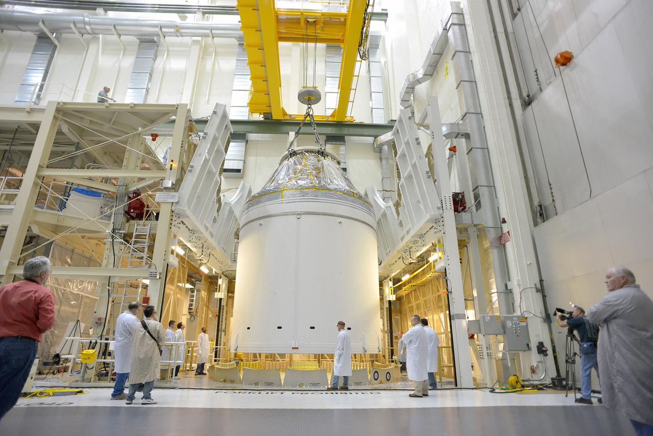 Technicians and engineers put finishing touches on the Orion Exploration Flight Test-1 (EFT-1) crew module and service module stack in the Operations and Checkout (O&amp;C) Building at Kennedy Space Center on Sept. 7, 2014. Part of Batch image transfer from Flickr.