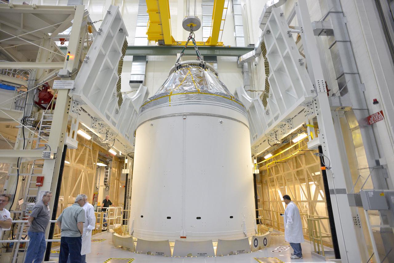 Technicians and engineers put finishing touches on the Orion Exploration Flight Test-1 (EFT-1) crew module and service module stack in the Operations and Checkout (O&amp;C) Building at Kennedy Space Center on Sept. 7, 2014. Part of Batch image transfer from Flickr.