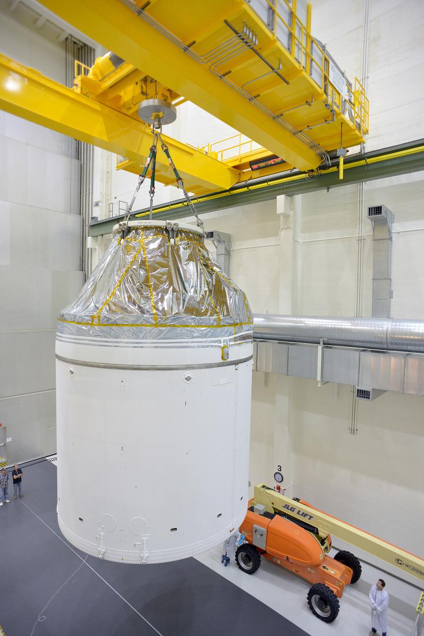 Technicians and engineers put finishing touches on the Orion Exploration Flight Test-1 (EFT-1) crew module and service module stack in the Operations and Checkout (O&amp;C) Building at Kennedy Space Center on Sept. 7, 2014. Part of Batch image transfer from Flickr.