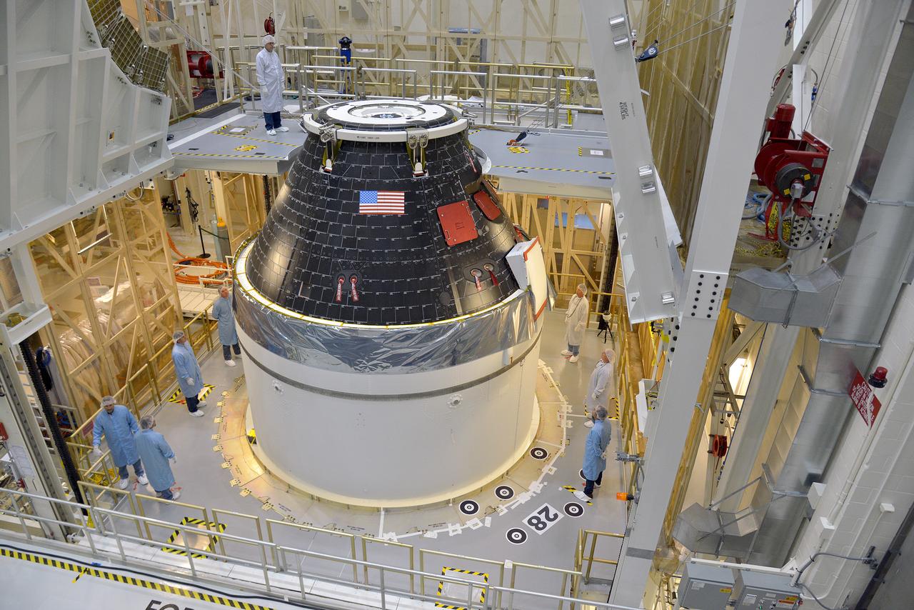 Technicians and engineers put finishing touches on the Orion Exploration Flight Test-1 (EFT-1) crew module and service module stack in the Operations and Checkout (O&amp;C) Building at Kennedy Space Center on Sept. 7, 2014. Part of Batch image transfer from Flickr.
