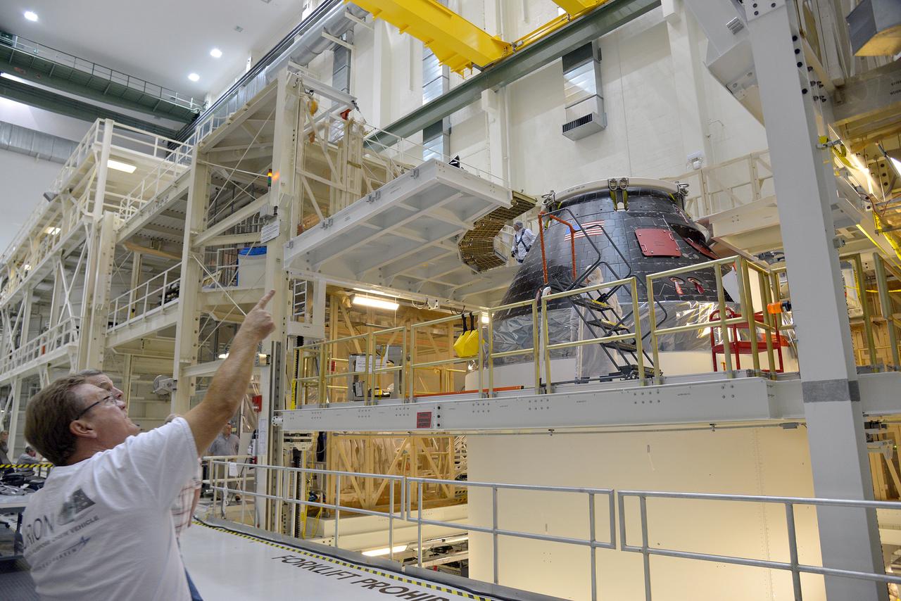 Technicians and engineers put finishing touches on the Orion Exploration Flight Test-1 (EFT-1) crew module and service module stack in the Operations and Checkout (O&C) Building at Kennedy Space Center on Sept. 7, 2014. Part of Batch image transfer from Flickr.