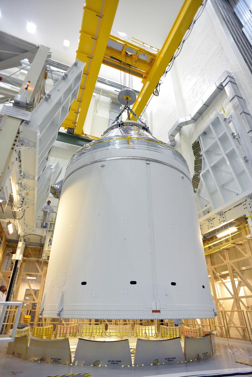 Technicians and engineers put finishing touches on the Orion Exploration Flight Test-1 (EFT-1) crew module and service module stack in the Operations and Checkout (O&amp;C) Building at Kennedy Space Center on Sept. 7, 2014. Part of Batch image transfer from Flickr.