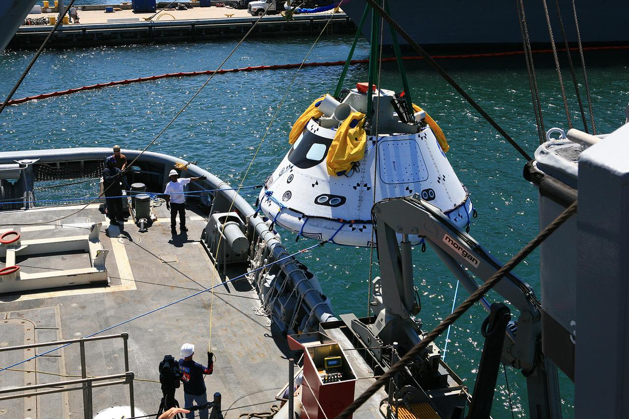 A test version of Orion is recovered from the Pacific Ocean using a crane on board the Navy's USS Salvor during tests on Sept. 12, 2014. A combined NASA and U.S. Navy team practiced recovery techniques off the coast of California over the course of the next week -- first with the crane, as seen here, then using the USS Anchorage's well deck -- in preparation for Exploration Flight Test-1 (EFT-1). Part of Batch image transfer from Flickr.
