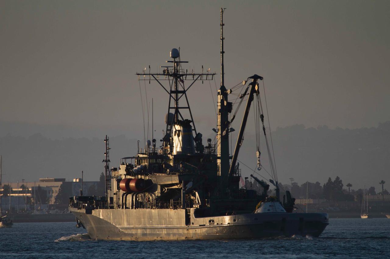 The Navy's USS Salvor makes its way out to sea with a test version of Orion on deck on Sept. 12, 2014. NASA and Navy personnel on board the Salvor used the ship's crane to test recovery techniques prior to Orion's first launch on Exploration Flight Test-1 (EFT-1).  Part of Batch image transfer from Flickr.