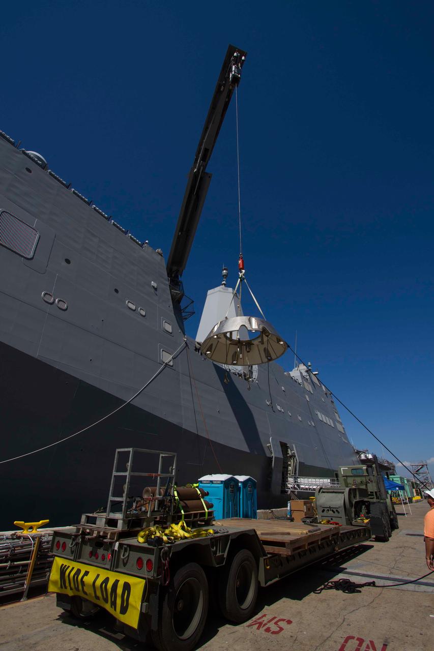 A test version of Orion's forward bay cover is loaded onto the Navy's USS Anchorage in preparation for testing Orion recovery tools and techniques in the Pacific Ocean off the coast of San Diego on Sept. 12, 2014. The forward bay cover protects the top section of Orion's crew module until the spacecraft is almost ready to land. It is jettisoned to allow Orion's parachutes to deploy and must be recovered separately from the crew module.  Part of Batch image transfer from Flickr.