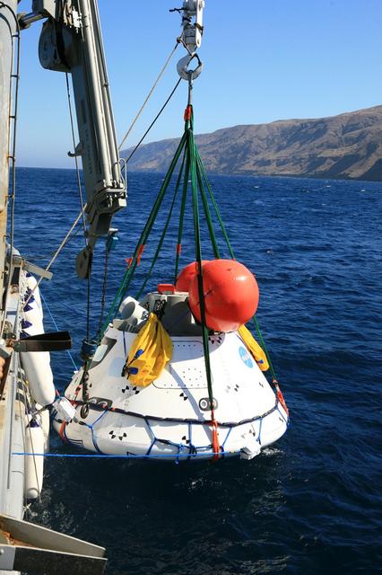 Recovery team members retrieve a test version of Orion from the Pacific Ocean using a crane on the Navy's USS Salvor on Sept. 13, 2014. A combined NASA and U.S. Navy team practiced recovery techniques off the coast of California over the course of the the week -- first with the Salvor's crane, then using the USS Anchorage's well deck -- in preparation for Exploration Flight Test-1 (EFT-1). Part of Batch image transfer from Flickr.