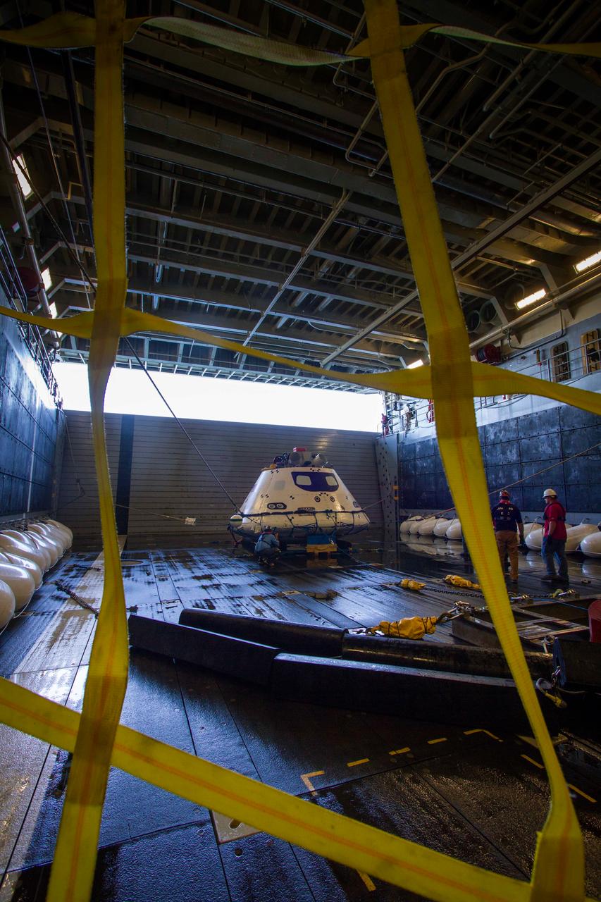 A test version of Orion awaits the next round of recovery tests inside of the USS Anchorage's well deck as the ship travels off the coast of California on Sept. 15, 2014. The well deck can be flooded with water to allow Orion to float in following its splashdown when it returns from space.  Part of Batch image transfer from Flickr.