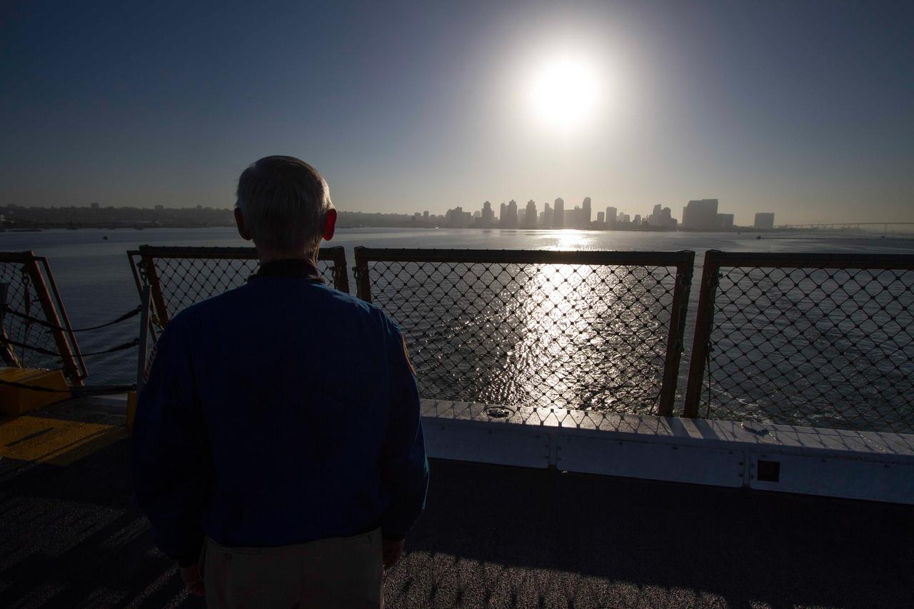 Former astronaut and Special Assistant for Orion Program Integration John Casper watches the San Diego skyline grow smaller in the distance as the Navy's USS Anchorage heads out to sea on Sept. 15, 2014. The ship is being used to test Orion recovery tools and techniques prior to Exploration Flight Test-1 (EFT-1).  Part of Batch image transfer from Flickr.