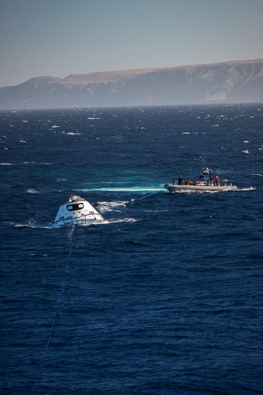 Recovery team members work to guide a test version of Orion into the USS Anchorage's well deck on Sept. 15, 2014. NASA and the Navy are working together to test tools and techniques that will be used to recover the spacecraft once it splashes down following Exploration Flight Test-1 (EFT-1). Part of Batch image transfer from Flickr.