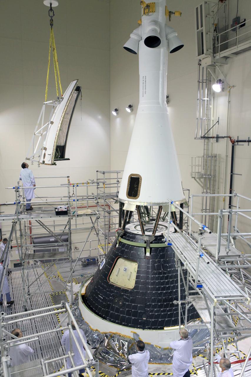The last major assembly operation to prepare Orion for Exploration Flight Test-1 (EFT-1) is completed in the Launch Abort System Facility (LASF) at Kennedy Space Center on Oct. 11, 2014. The ogive panels, which protect the crew module from sound and vibration during ascent, were installed around the spacecraft just below the launch abort system tower. Part of Batch image transfer from Flickr.