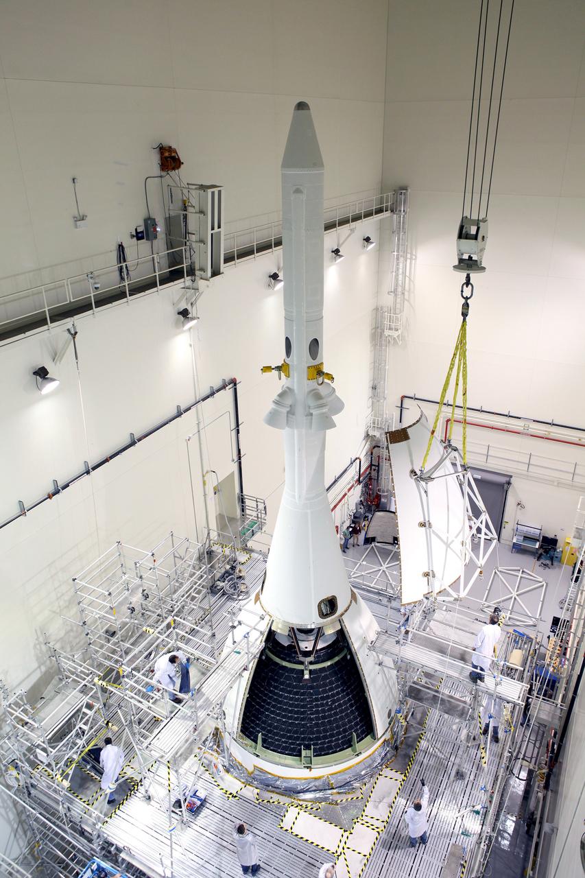The last major assembly operation to prepare Orion for Exploration Flight Test-1 (EFT-1) is completed in the Launch Abort System Facility (LASF) at Kennedy Space Center on Oct. 11, 2014. The ogive panels, which protect the crew module from sound and vibration during ascent, were installed around the spacecraft just below the launch abort system tower. Part of Batch image transfer from Flickr.
