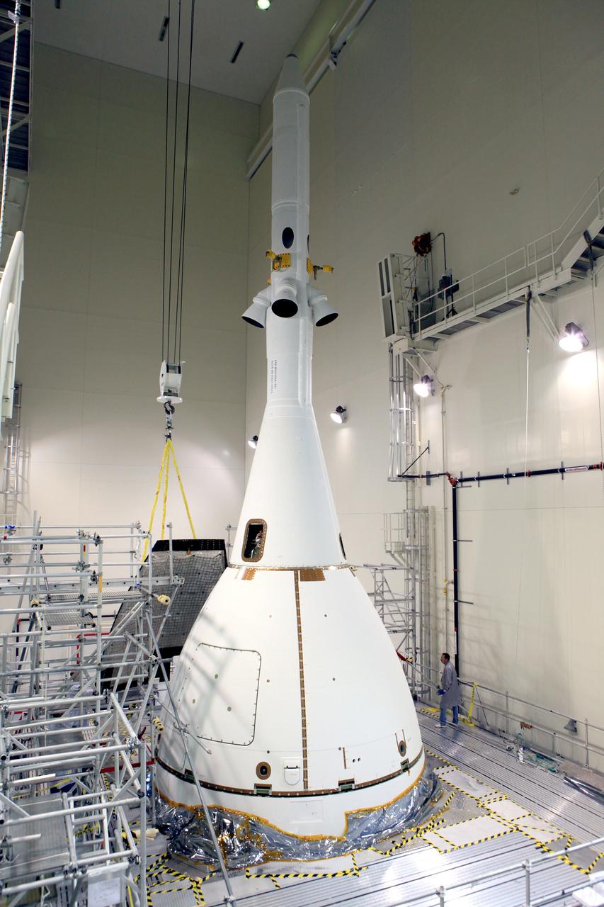 The last major assembly operation to prepare Orion for Exploration Flight Test-1 (EFT-1) is completed in the Launch Abort System Facility (LASF) at Kennedy Space Center on Oct. 11, 2014. The ogive panels, which protect the crew module from sound and vibration during ascent, were installed around the spacecraft just below the launch abort system tower. Part of Batch image transfer from Flickr.