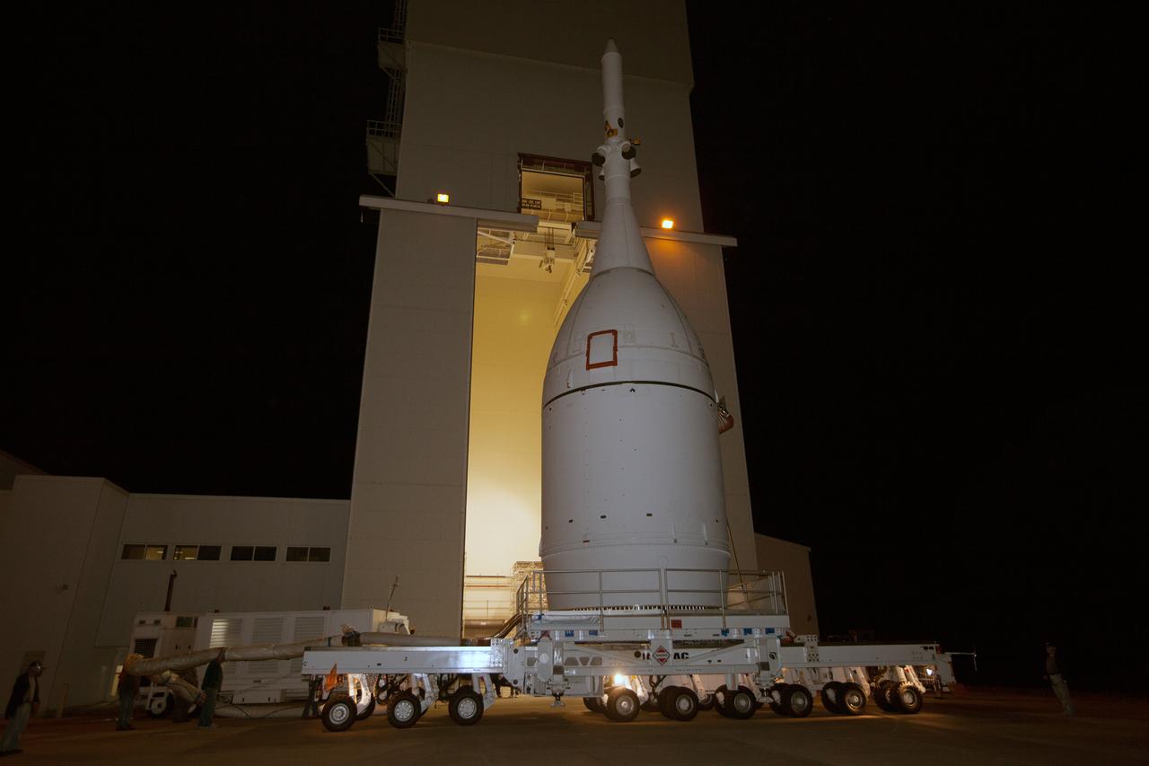 At NASA's Kennedy Space Center in Florida, the agency's Orion spacecraft pauses in front of the spaceport's iconic Vehicle Assembly Building as it is transported to Launch Complex 37 at Cape Canaveral Air Force Station on Nov. 11, 2014. After arrival at the launch pad, United Launch Alliance engineers and technicians lifted Orion and mounted it atop its Delta IV Heavy rocket. Part of Batch image transfer from Flickr.