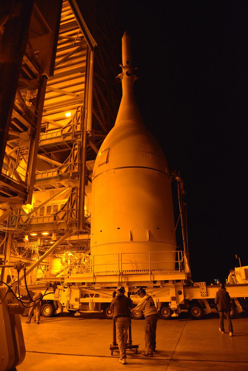 Engineers and technicians at Space Launch Complex 37 move Orion into place in the service structure so the spacecraft can be lifted and joined to the top of the Delta IV Heavy rocket on Nov. 12, 2014.  Part of Batch image transfer from Flickr.