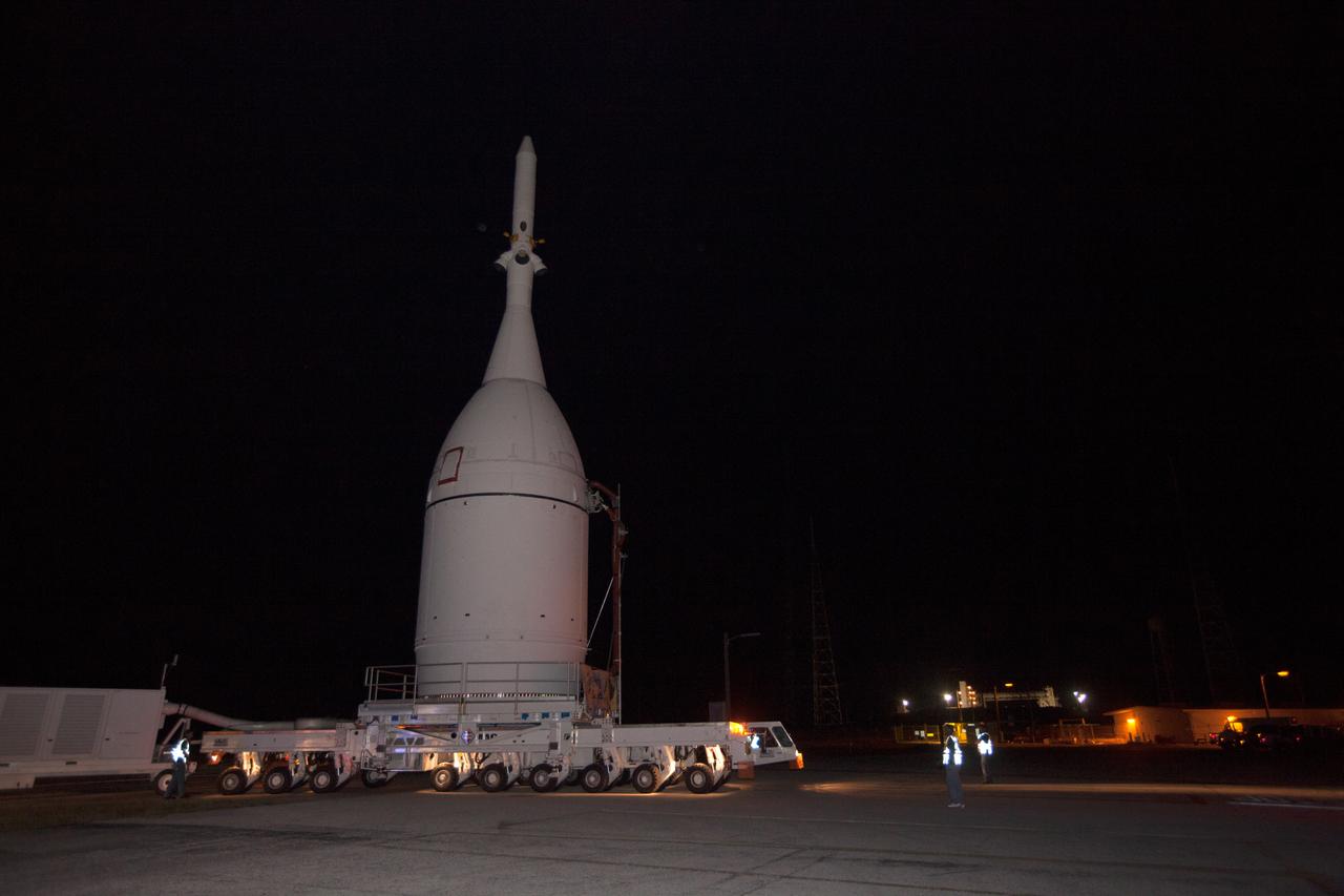 At NASA's Kennedy Space Center in Florida, the agency's Orion spacecraft passes by Launch Complex 39B as it is transported to Launch Complex 37 at Cape Canaveral Air Force Station on Nov. 12, 2014. After arrival at the launch pad, United Launch Alliance engineers and technicians lifted Orion and mounted it atop its Delta IV Heavy rocket. Part of Batch image transfer from Flickr.