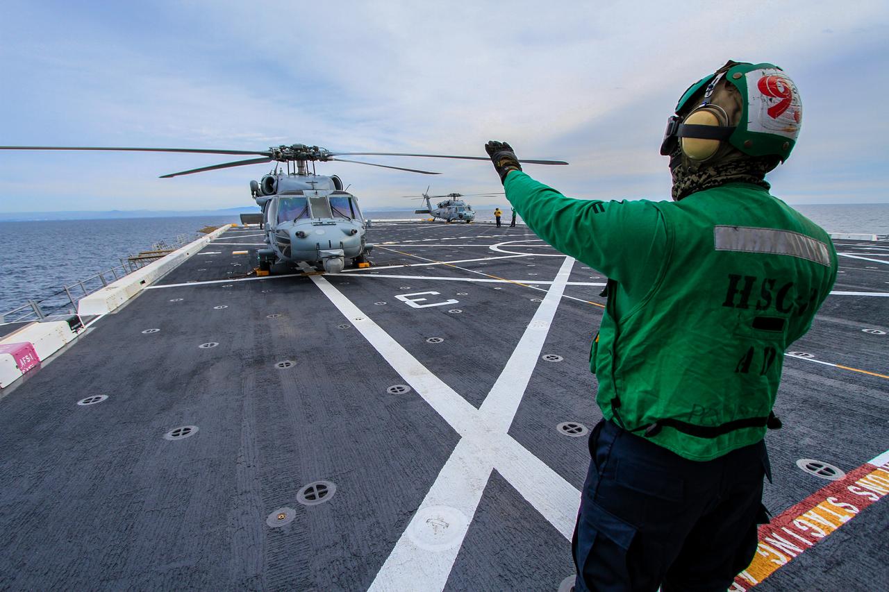 A helicopter lands on the flight deck of the USS Anchorage as the Navy ship makes its way to the recovery zone for NASA's Orion spacecraft on Dec. 1, 2014. Orion is scheduled to launch on Exploration Flight Test-1 (EFT-1) from Florida on Dec. 4, and splashdown 4.5 hours later in the Pacific Ocean, where it will be picked up by the Anchorage. Part of Batch image transfer from Flickr.