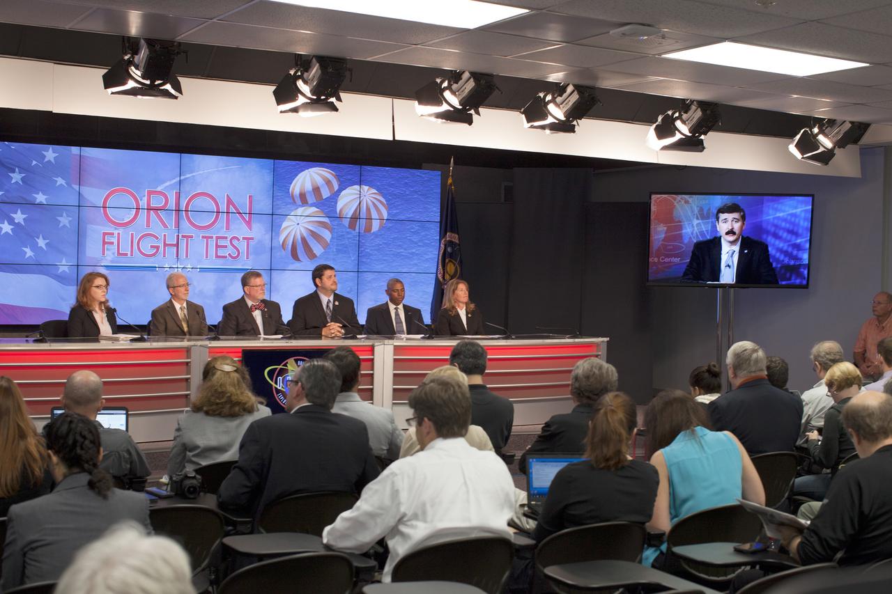 In the Kennedy Space Center’s Press Site auditorium, agency and industry leaders spoke to members of the news media as the Orion spacecraft and its Delta IV Heavy rocket were being prepared for launch on Dec. 3, 2014. From left are: Brandi Dean of NASA Public Affairs, Mark Geyer, Orion program manager, Mike Hawes, Lockheed Martin Orion Program manager, Jeff Angermeier, Exploration Flight Test-1 Ground Systems Development and Operations mission manager, Ron Fortson, United Launch Alliance director of mission management, and Kathy Winters, U.S. Air Force 45th Space Wing Launch Weather officer. On the right, Mike Sarafin, Orion flight director, participated via video from the Johnson Space Center. Part of Batch image transfer from Flickr.