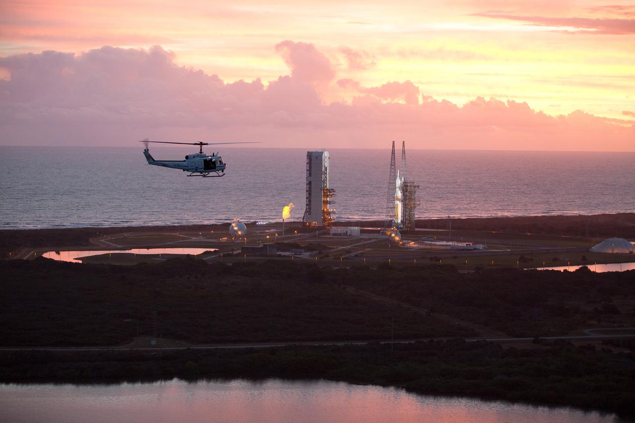 This helicopter view of the NASA Causeway connecting NASA's Kennedy Space Center with Cape Canaveral Air Force Staton shows the thousands of vehicles parked where guests gather to see the launch of the Orion Exploration Flight Test-1 (EFT-1) on Dec. 4, 2014. The liftoff was postponed because of an issue related to fill and drain valves on the Delta IV Heavy rocket that teams could not troubleshoot by the time the launch window expired. Part of Batch image transfer from Flickr.