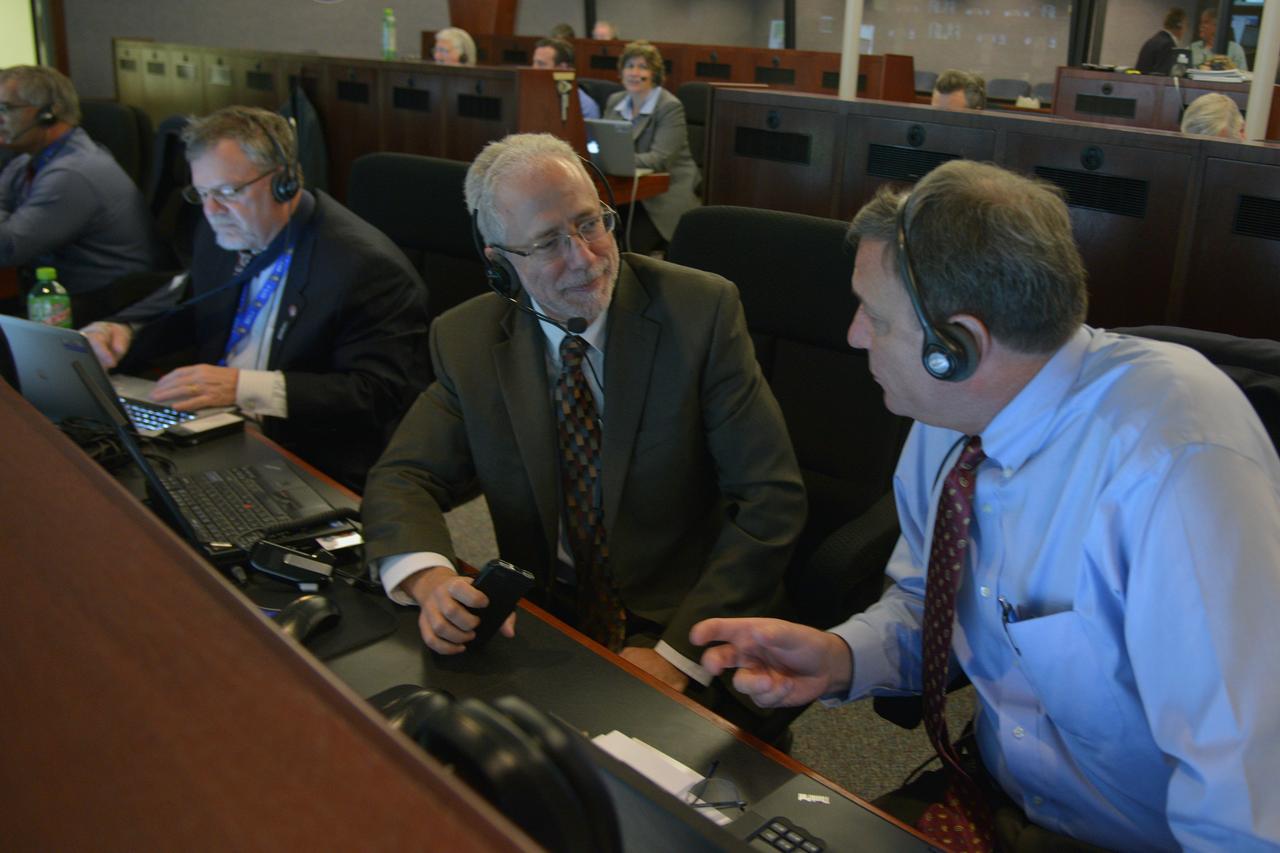 The Orion program management team reviews the launch procedure in Building AE at Cape Canaveral Air Force Station ahead of the launch of Orion on Exploration Flight Test-1 (EFT-1) on Dec. 4, 2014. Pictured from left to right: Mike Hawes, Lockheed Martin Orion program manager, Mark Geyer, NASA Orion program manager, and Mark Kirasich, NASA Orion deputy program manager.  Part of Batch image transfer from Flickr.