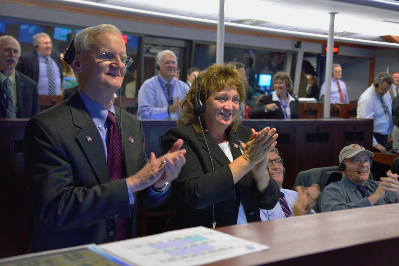Astronaut John Casper and Lockheed Martin's Carol Webber watch Orion's parachutes open during the Exploration Flight Test-1 (EFT-) landing sequence on Dec. 5, 2014. The Orion spacecraft orbited Earth twice, reaching an altitude of approximately 3,600 miles above Earth before landing. No one was aboard Orion for this flight test, but the spacecraft is designed to allow us to journey to destinations never before visited by humans, including an asteroid and Mars. Part of Batch image transfer from Flickr.