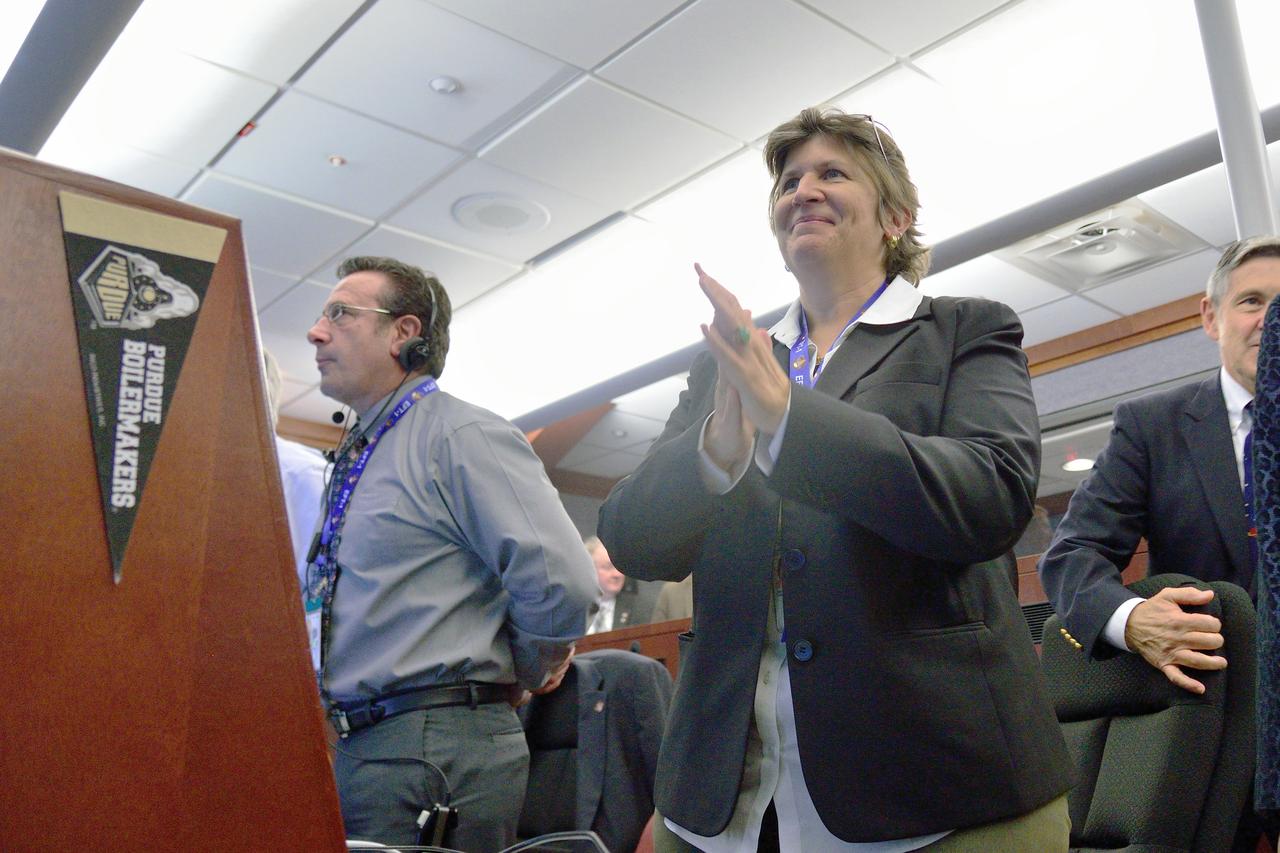 Orion Chief Engineer Julie Kramer celebrates Orion's successful splashdown in the Pacific Ocean after Exploration Flight Test-1 (EFT-1) in Building AE at Cape Canaveral Air Force Station on Dec. 5, 2014. The Orion spacecraft orbited Earth twice, reaching an altitude of approximately 3,600 miles above Earth before landing. No one was aboard Orion for this flight test, but the spacecraft is designed to allow us to journey to destinations never before visited by humans, including an asteroid and Mars. Part of Batch image transfer from Flickr.