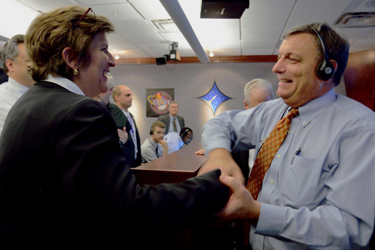 Orion Chief Engineer Julie and Deputy Program Manager Mark Kirasich celebrate Orion's successful Exploration Flight Test-1 (EFT-1) mission in Building AE at Cape Canaveral Air Force Station on Dec. 5, 2014. The Orion spacecraft orbited Earth twice, reaching an altitude of approximately 3,600 miles above Earth before landing. No one was aboard Orion for this flight test, but the spacecraft is designed to allow us to journey to destinations never before visited by humans, including an asteroid and Mars. Part of Batch image transfer from Flickr.