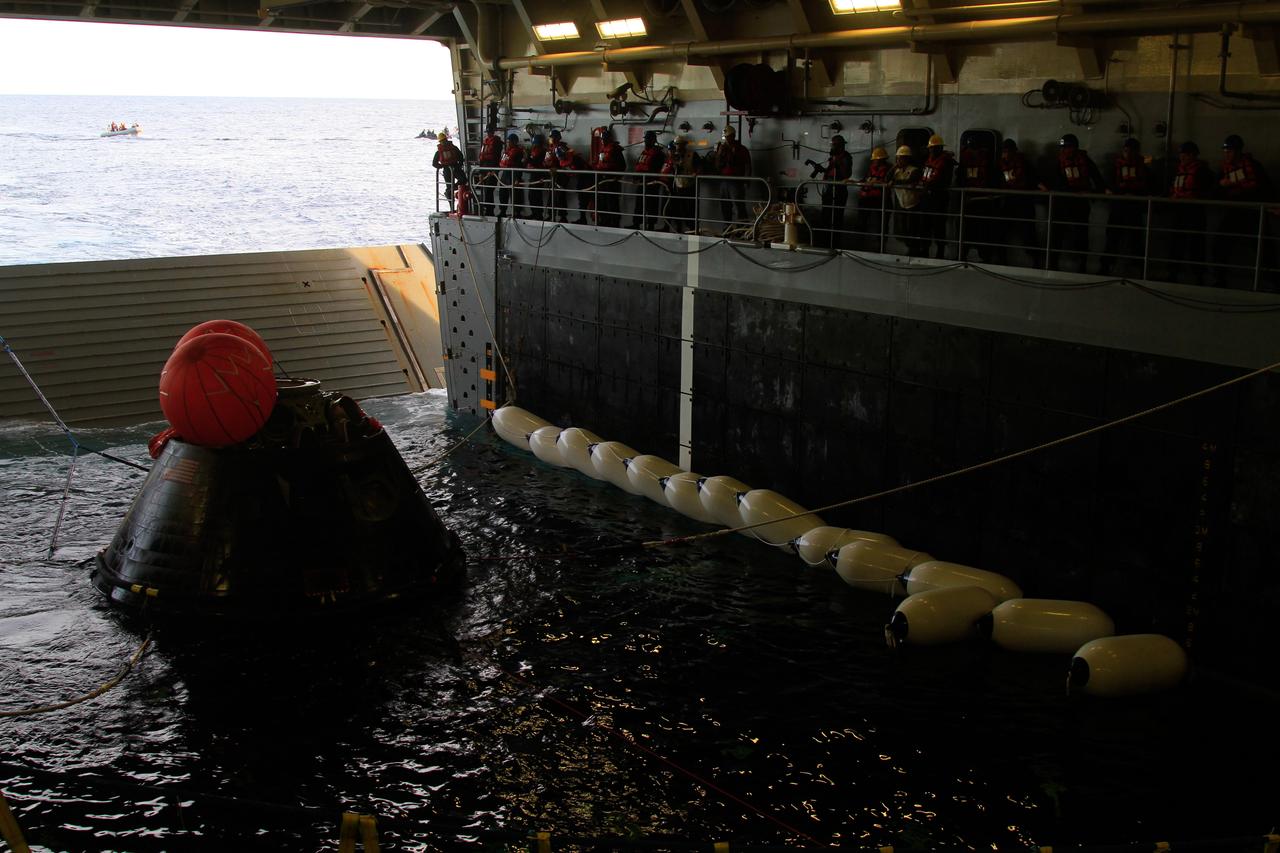 NASA’s Orion spacecraft is pulled safely into the well deck of the U.S. Navy’s USS Anchorage, following its splashdown in the Pacific Ocean. Orion launched into space on a two-orbit, 4.5-test flight at 7:05 am EST on Dec. 5, and returned safely to Earth, where a combined team from NASA, the Navy and Orion prime contractor Lockheed Martin retrieved it for return to shore. Over the next several days, the team will perform an initial check out of Orion while the Anchorage transports the spacecraft back to shore. It is expected to be off loaded at Naval Base San Diego on Monday. Part of Batch image transfer from Flickr.